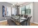 Bright dining room featuring modern chandelier, neutral walls, and expansive window at 8180 Valhalla Ter, Reunion, FL 34747
