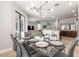 Dining room featuring modern chandelier with easy access to living room at 8180 Valhalla Ter, Reunion, FL 34747