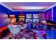Vibrant game room featuring multiple arcade games, bar table, and colorful lighting at 8180 Valhalla Ter, Reunion, FL 34747