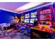 A vibrant game room featuring arcade games, a basketball game, and neon lighting for entertainment at 8180 Valhalla Ter, Reunion, FL 34747