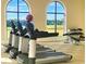 Well-equipped gym featuring treadmills, free weights, and panoramic views for an energizing workout experience at 8180 Valhalla Ter, Reunion, FL 34747