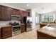 Well-equipped kitchen features stainless steel appliances, granite counters and ample cabinet space at 8180 Valhalla Ter, Reunion, FL 34747