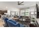 Open-concept living room featuring stylish furnishings and view to dining room and bar seating at 8180 Valhalla Ter, Reunion, FL 34747