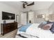 Comfortable main bedroom with soft decor, dresser, fan, and easy access to bath at 8180 Valhalla Ter, Reunion, FL 34747