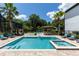 Backyard featuring a pool, spa, tiki bar, chess set, and cabana, creating an inviting and entertaining outdoor oasis at 8180 Valhalla Ter, Reunion, FL 34747