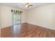 Bedroom featuring wood floors, sliding glass doors to the outdoor patio, and ceiling fan at 916 Glendale St, Orlando, FL 32807