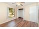 Bright bedroom features wood laminate flooring, a ceiling fan, closet, and a window at 916 Glendale St, Orlando, FL 32807