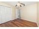 Bedroom featuring wood laminate flooring, a ceiling fan, and a closet at 916 Glendale St, Orlando, FL 32807