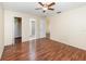 Large bedroom featuring wood floors, ceiling fan, and access to the ensuite bathroom at 916 Glendale St, Orlando, FL 32807
