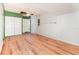 Large flex room with wood laminate flooring, white brick walls, and a ceiling fan at 916 Glendale St, Orlando, FL 32807