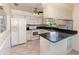 Bright kitchen featuring white appliances, tile flooring, and a breakfast bar area at 916 Glendale St, Orlando, FL 32807