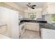 Cozy kitchen with white appliances, tile flooring, and a window over the sink at 916 Glendale St, Orlando, FL 32807