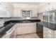 Charming kitchen featuring tile flooring, black countertops, and white cabinetry at 916 Glendale St, Orlando, FL 32807