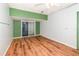 Unfinished room featuring wood-look floors, white block walls, and a sliding glass door at 916 Glendale St, Orlando, FL 32807