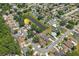 High angle aerial view shows the property's location within a residential neighborhood and close to a pond at 2527 Christine Dr, Kissimmee, FL 34744