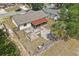 Aerial view of fenced backyard with mature trees, fire pit, patio, and screened-in porch at 2527 Christine Dr, Kissimmee, FL 34744