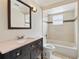 This bathroom features a bathtub, shower, wooden framed mirror and single sink vanity at 2527 Christine Dr, Kissimmee, FL 34744