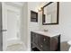 This bathroom features a single sink vanity, framed mirror and an adjacent doorway at 2527 Christine Dr, Kissimmee, FL 34744