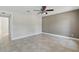 This spacious bedroom features neutral colors, a ceiling fan, and tile floors at 2527 Christine Dr, Kissimmee, FL 34744