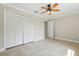 A bedroom featuring a ceiling fan, closet, and neutral color palette with tile floors at 2527 Christine Dr, Kissimmee, FL 34744