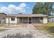 Ranch home has a nice sunroom and a gravel and brick walkway at 2527 Christine Dr, Kissimmee, FL 34744