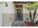 Close-up of the home's entrance, with stone facade and a view of the front door at 2527 Christine Dr, Kissimmee, FL 34744