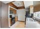 Kitchen featuring updated appliances, tile floors, and overhead lighting at 2527 Christine Dr, Kissimmee, FL 34744
