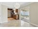 The kitchen has standard appliances and tile flooring and is next to the dining and sunroom at 2527 Christine Dr, Kissimmee, FL 34744