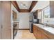 Functional kitchen featuring wood cabinets, updated appliances, and a tile backsplash at 2527 Christine Dr, Kissimmee, FL 34744