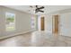 Bright primary bedroom with tile flooring, a ceiling fan, and access to a walk-in closet at 2527 Christine Dr, Kissimmee, FL 34744