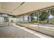 The sunroom with its tile floor looks out onto the lush green backyard and trees at 2527 Christine Dr, Kissimmee, FL 34744