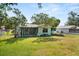 View of the home's fenced-in backyard, featuring a screen porch at 1007 3Rd St, Port Orange, FL 32129
