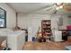 Unfinished basement with exposed laundry area, storage and ceiling fan at 1007 3Rd St, Port Orange, FL 32129