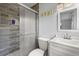 Bathroom featuring gray wood-look tile walls, glass shower doors, and a modern white vanity at 1007 3Rd St, Port Orange, FL 32129