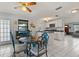 Open kitchen and dining area with white cabinets, stainless steel appliances, and an adjacent living space at 1007 3Rd St, Port Orange, FL 32129