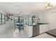 Bright kitchen featuring stainless steel appliances, white cabinets, an island with a sink, and an adjacent dining area at 1007 3Rd St, Port Orange, FL 32129