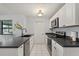 Modern kitchen features sleek countertops, stainless steel appliances, and white cabinetry at 1007 3Rd St, Port Orange, FL 32129