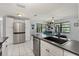 Modern kitchen showcasing stainless steel appliances, white cabinetry, contrasting countertops, and a dining area at 1007 3Rd St, Port Orange, FL 32129
