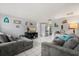Inviting living room with a cozy sofa, entertainment center, and seamless connection to the kitchen, ideal for gatherings at 1007 3Rd St, Port Orange, FL 32129