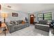 Cozy living room featuring a comfortable sofa, neutral tones, and a front door entryway for a welcoming feel at 1007 3Rd St, Port Orange, FL 32129