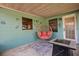 Covered patio features an egg chair, modern seating, and a ceiling fan at 1007 3Rd St, Port Orange, FL 32129