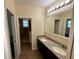 Modern bathroom featuring double sinks, granite countertops, and a glass-enclosed shower at 10631 Village Lake Rd, Windermere, FL 34786