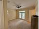 A light and airy room featuring a ceiling fan and access to the backyard at 10631 Village Lake Rd, Windermere, FL 34786