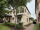 This charming two-story townhome has shutters and a landscaped walkway at 10631 Village Lake Rd, Windermere, FL 34786