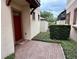 Inviting front entrance with red door and landscaped walkway at 10631 Village Lake Rd, Windermere, FL 34786