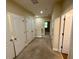 Hallway with neutral paint, carpet, storage closets, and doorways to other rooms at 10631 Village Lake Rd, Windermere, FL 34786