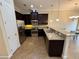 Kitchen featuring dark cabinets, stainless appliances, and tile floors at 10631 Village Lake Rd, Windermere, FL 34786