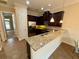 Kitchen features dark cabinets, granite counters, and stainless steel appliances at 10631 Village Lake Rd, Windermere, FL 34786