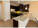 Kitchen features dark cabinets, granite counters, and stainless steel appliances at 10631 Village Lake Rd, Windermere, FL 34786