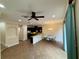 Open-concept living space with modern lighting, ceiling fan, breakfast bar and tile flooring at 10631 Village Lake Rd, Windermere, FL 34786